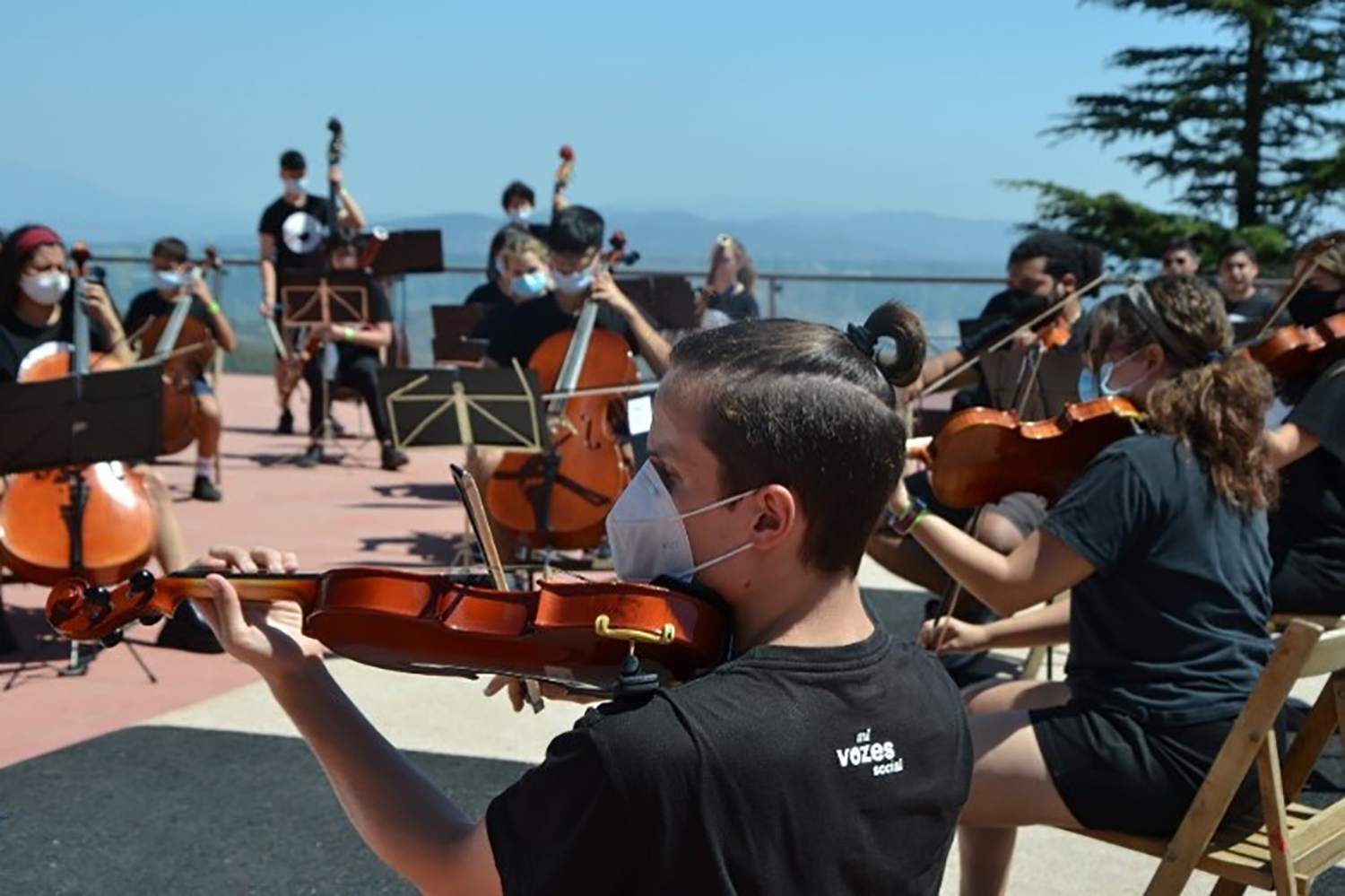 Jóvenes de la orquesta Vozes tocando música en el Tibidabo